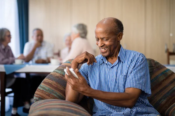 senior man looking at mobile phone