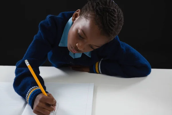 Colegiala haciendo su tarea — Foto de Stock