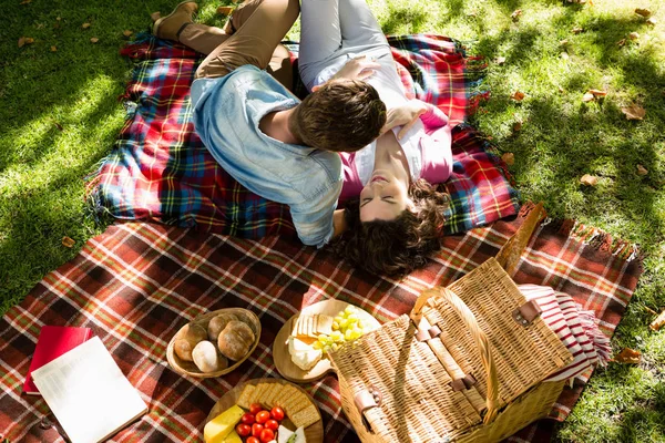 ロマンチックなカップルは公園でピクニック毛布の上に横たわる — ストック写真