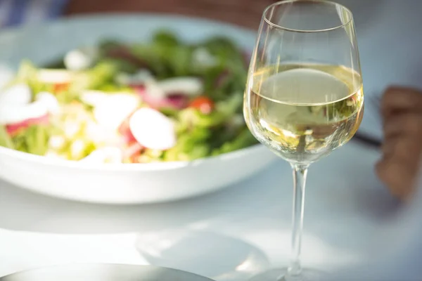 Comida y copa de vino en la mesa de comedor — Foto de Stock