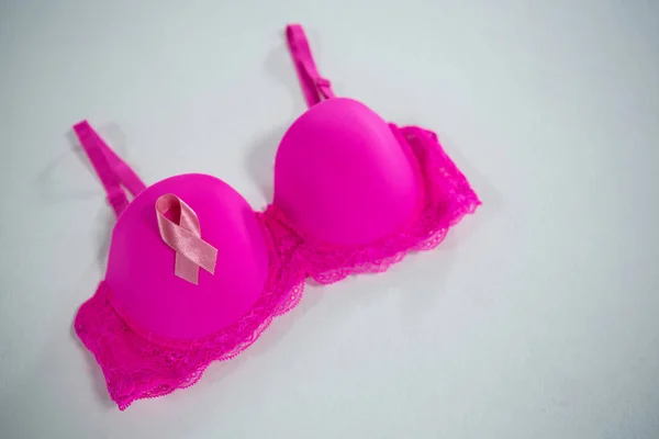 Breast Cancer Awareness ribbon on pink bra — Stock Photo, Image