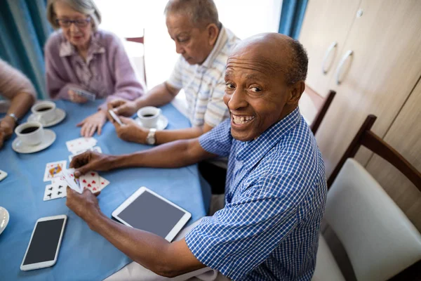 Senior mannen spelkort med vänner — Stockfoto