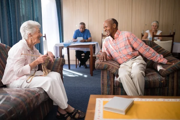 Cheerful senior man talking with woman — Stock Photo, Image