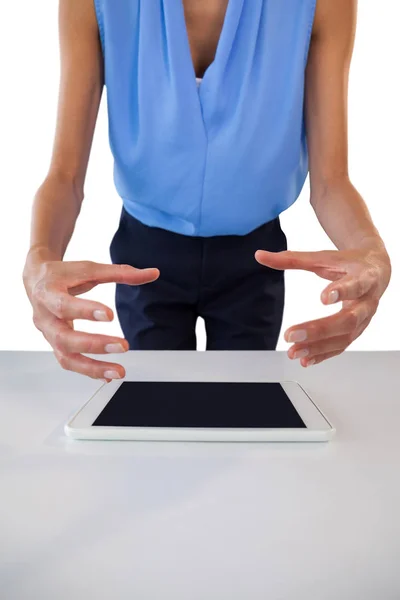 Businesswoman gesturing over tablet — Stock Photo, Image