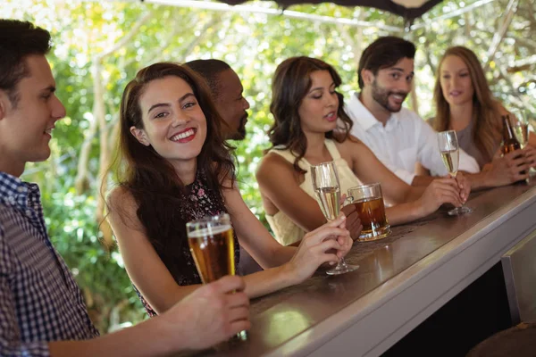 Friends interacting while having a alcohol — Stock Photo, Image