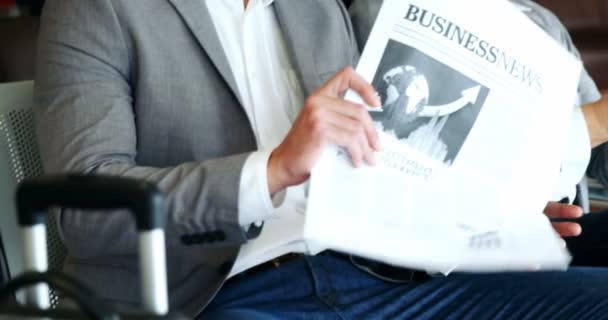 Бизнесмен держит газету и взаимодействует с женщиной — стоковое видео