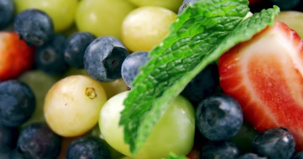 Fruits and herbs in bowl — Stock Video