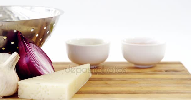 Cheese, onion and garlic with colander — Stock Video
