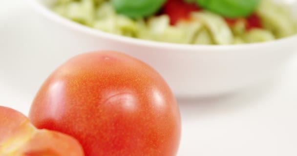 Cherry tomato with bowl of pasta — Stock Video