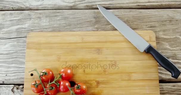 Cherry tomatoes and kitchen knife — Stock Video