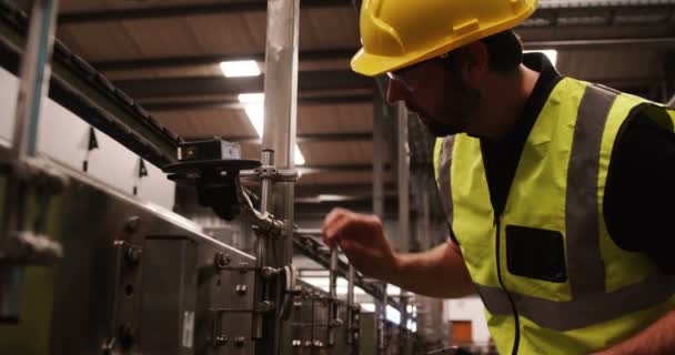 Worker using digital tablet while checking machinery — Stock Video