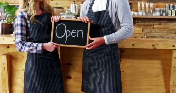 Waiter and waitresses holding open sign board — Stock Video