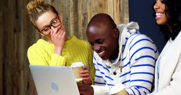 Vrienden met behulp van de laptop terwijl het hebben van koffie — Stockvideo