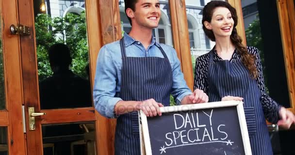 Waiter and waitresses standing with menu board — Stock Video