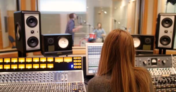 Female audio engineer using sound mixer — Stock Video