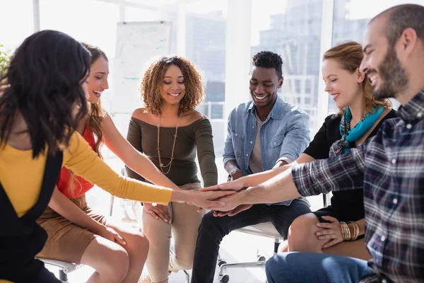 Happy colleagues forming hand stack — Stock Photo, Image