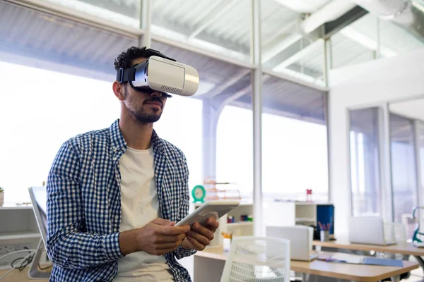 Male executive using virtual reality headset