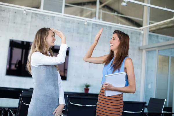 Female executives giving high five — Stock Photo, Image