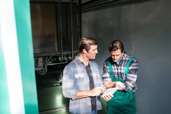 Coworkers discussing over digital tablet — Stock Photo, Image