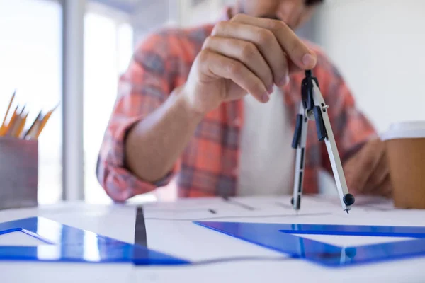 Male architect working on blueprint — Stock Photo, Image