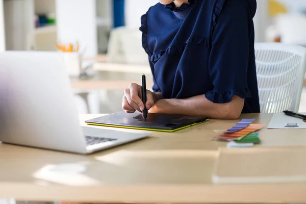 Vrouwelijke uitvoerend werkt via laptop en tablet — Stockfoto