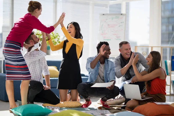 Business colleagues giving high five to each other — Stock Photo, Image