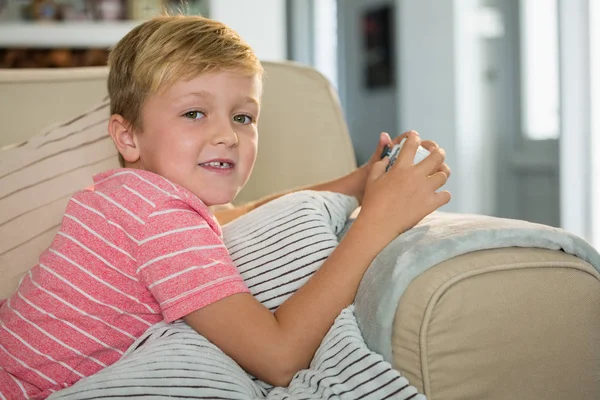 男孩在客厅玩电子游戏 — 图库照片