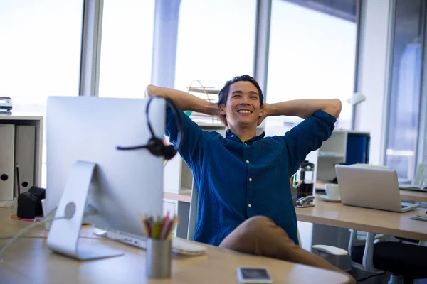 Male executive relaxing at his desk — Stock Photo, Image