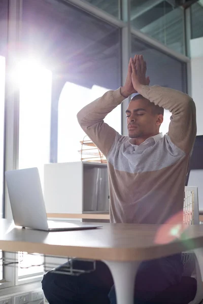 Male executive doing yoga — Stock Photo, Image