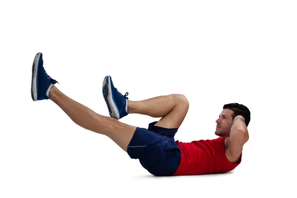 Sports player exercising while lying down — Stock Photo, Image