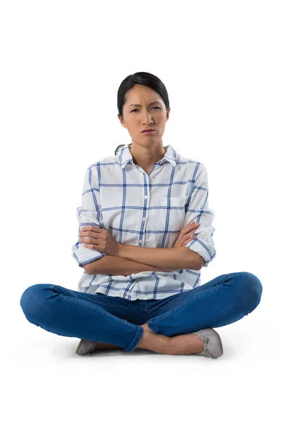 Worried woman sitting with arms crossed — Stock Photo, Image