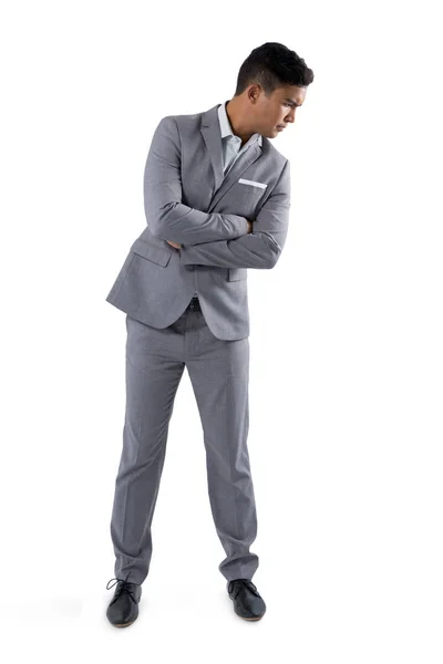 Uomo d'affari in piedi con le braccia incrociate — Foto Stock