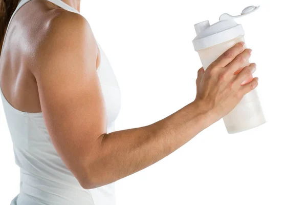 Female athlete holding bottle — Stock Photo, Image