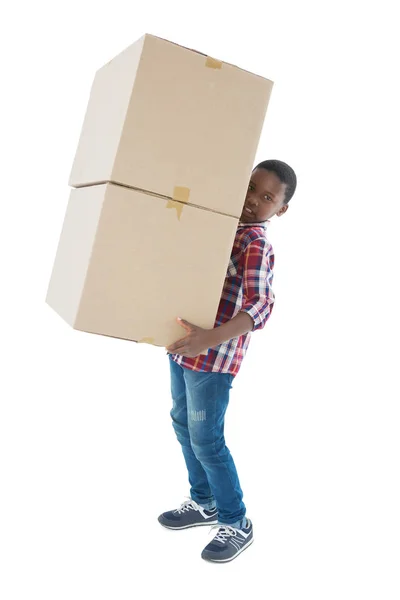 Boy carrying heavy boxes — Stock Photo, Image