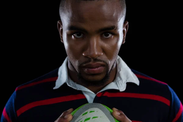 Desportista segurando bola de rugby — Fotografia de Stock