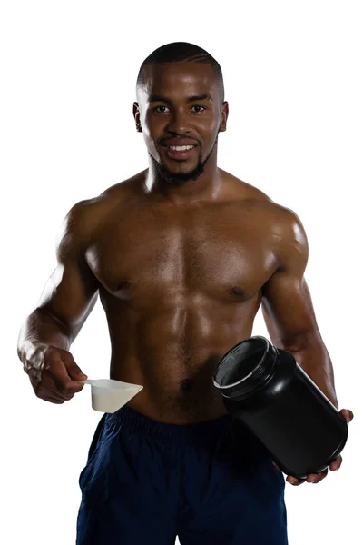 Shirtless αρσενικό αθλητής κρατώντας συμπλήρωμα βάζο — Φωτογραφία Αρχείου