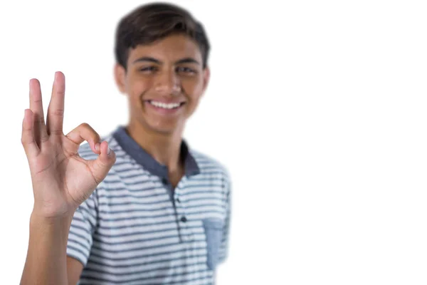 Smiling teenage boy gesturing okay hand sign — Stock Photo, Image