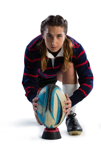 Female athlete keeping rugby ball on tee — Stock Photo, Image