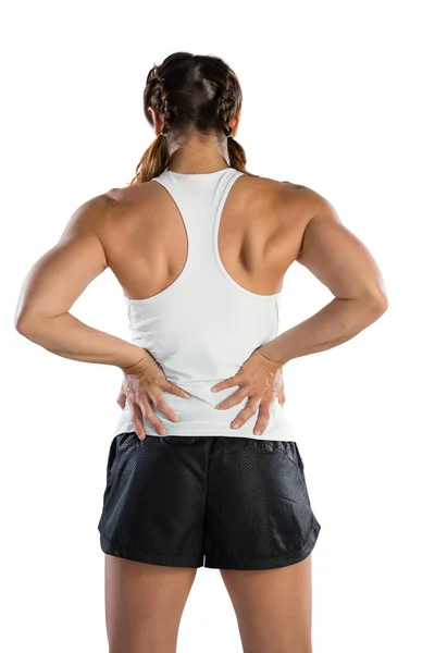 Sportswoman suffering from back pain — Stock Photo, Image
