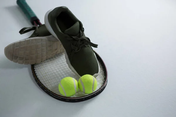 sports shoe with tennis ball and racket