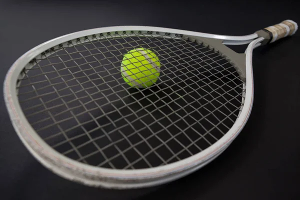 Tennis racket on ball — Stock Photo, Image