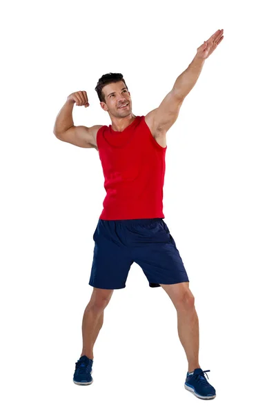 Jugador deportivo flexionando los músculos con la mano levantada —  Fotos de Stock