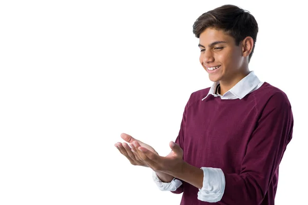 Junge gibt vor, einen unsichtbaren Gegenstand in der Hand zu halten — Stockfoto