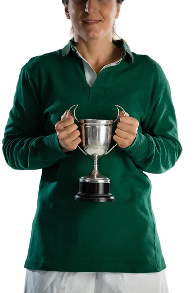 Smiling female rugby player holding trophy — Stock Photo, Image