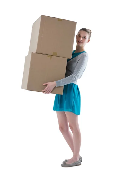 Teenager girl carrying heavy boxes — Stock Photo, Image