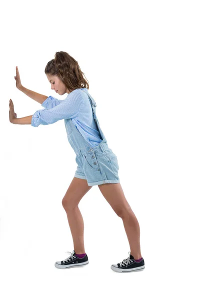 Teenage girl pushing against white — Stock Photo, Image