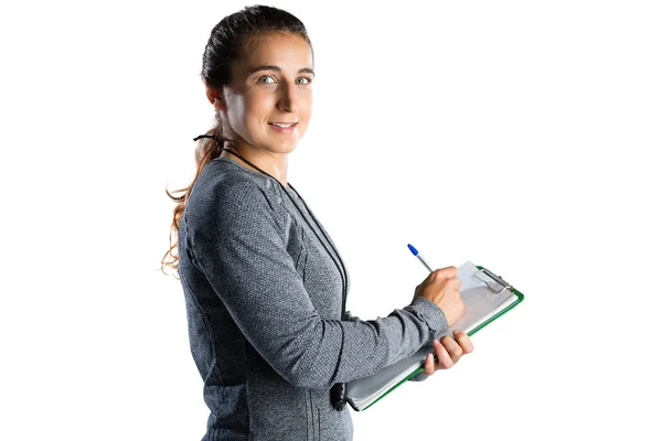Rugby coach writing on clipboard — Stock Photo, Image