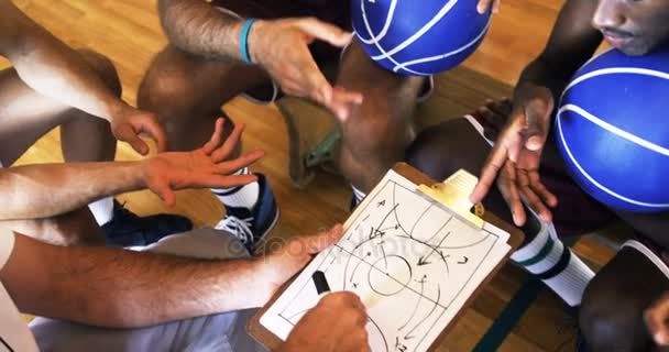 Coach assisting players on clipboard clipboard — Stock Video