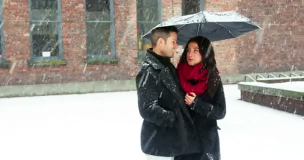Par som interagerar med varandra under paraply — Stockvideo