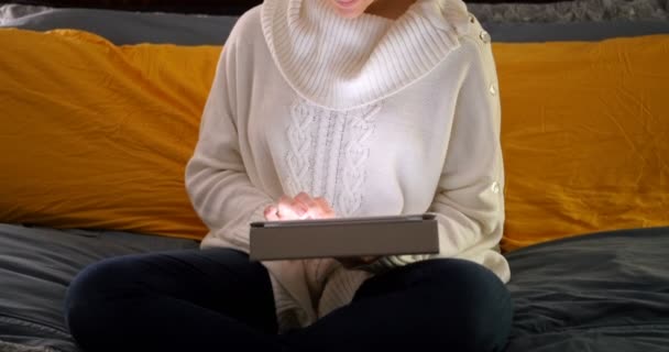 Женщина с помощью цифрового планшета на кровати — стоковое видео